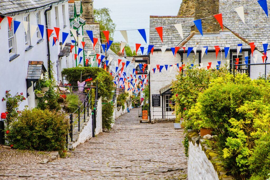 cobbled lane in Clovelly with flowers and flags