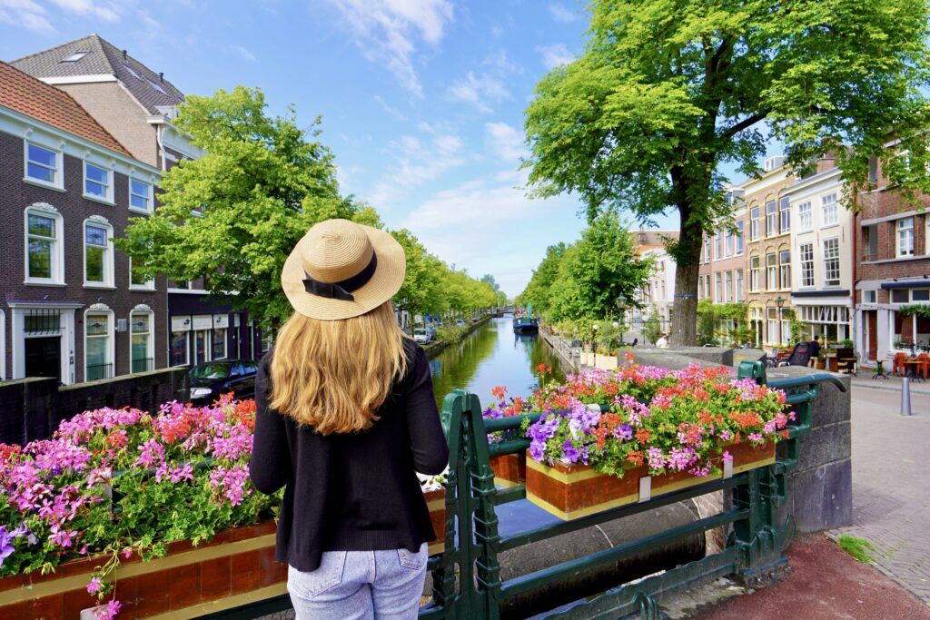 young woman in front of flowers on a canal in Utrecht