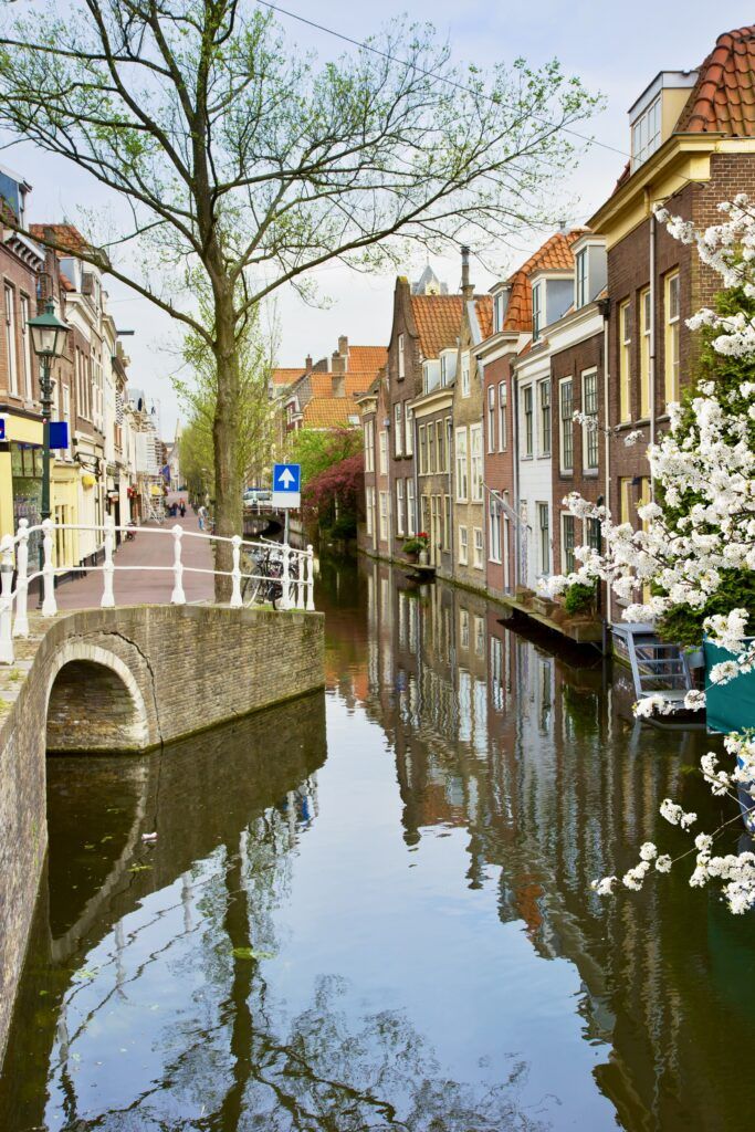 canal in Delft lined with beautiful buildings