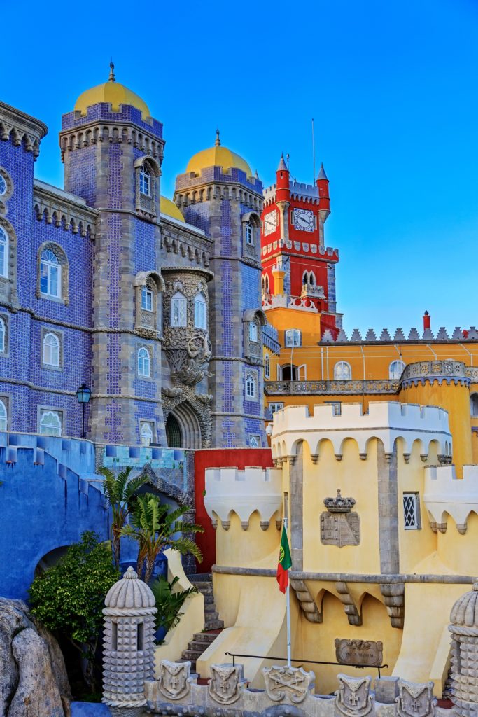 red clock tower and blue mosaic towers