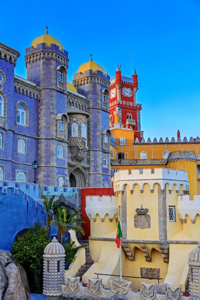 red clock tower and blue mosaic towers