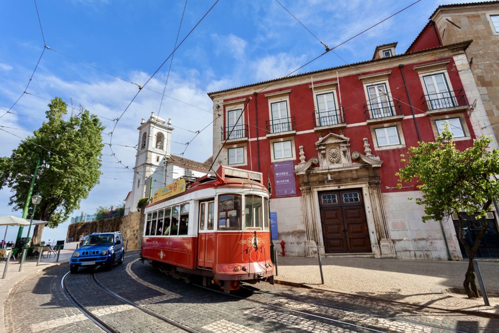 red tram in front of the Museum of Decorative Arts