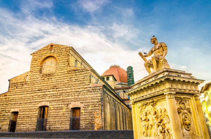 the raw brownstone facade of the Basilica of San Lorenzo