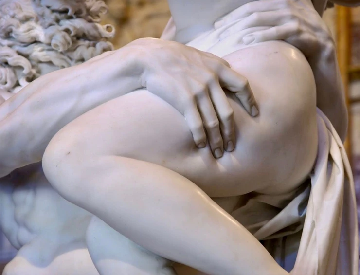 detail where the marble looks so real that indentations appear on Persephone's thigh