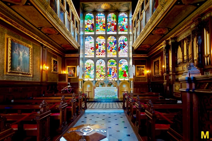stained glass windows and pews in the chapel of Hatfield House