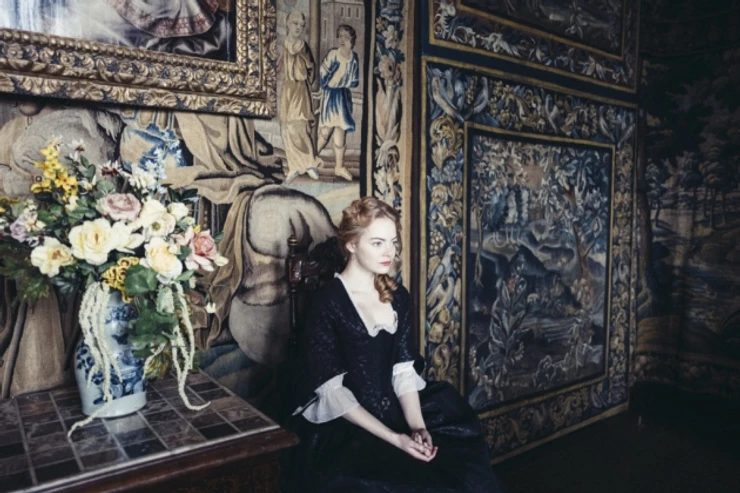 Emma Stone, who plays Abigail, sitting in the King James Drawing Room