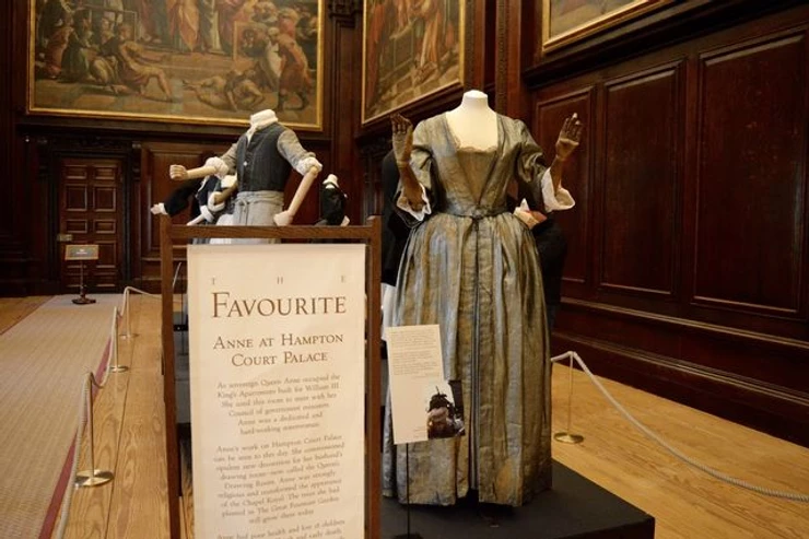 costumes from The Favourite on display in the Cartoon Room of Hampton Court Palace