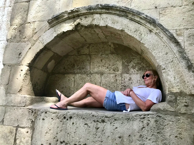 me relaxing in a niche in Les Alyscamps