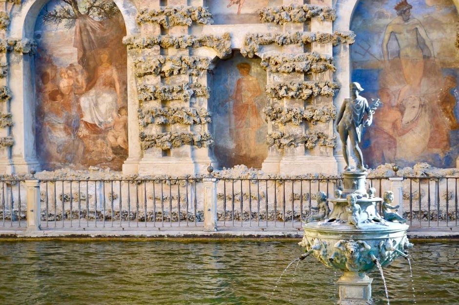 the Mercury statue set against frescos in the Mercury Pool in the Alcazar Gardens