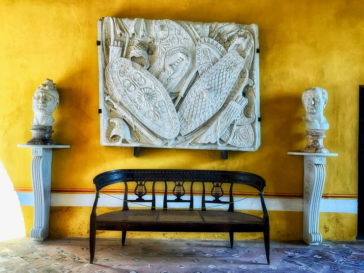 the ochre hued Golden Room containing classical sculptures and reliefs from Italy