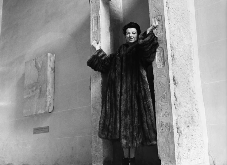 Peggy Guggenheim at her palazzo in a coat from her fur collection