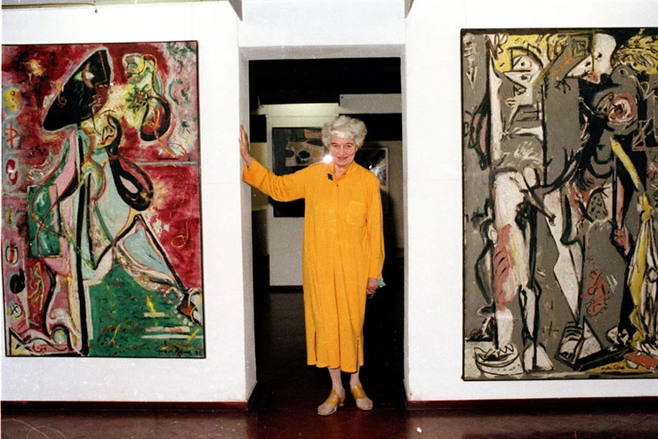 Peggy Guggenheim poses with her early Pollocks