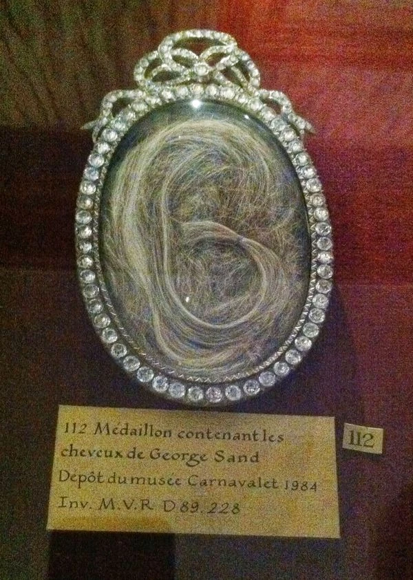 Not only do you get to see a cast of Sand's arm, but there's also this medallion with her hair
