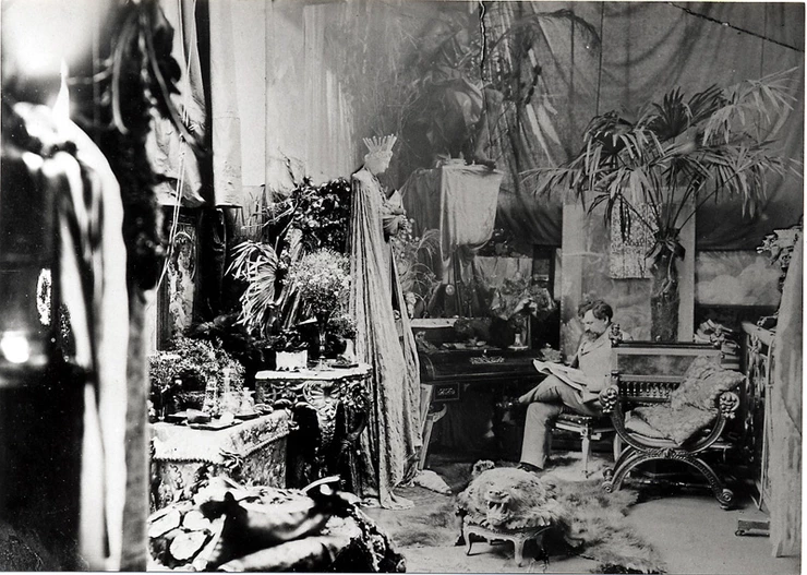 This is the messy Parisian studio of artist Alphonse Mucha, a pioneer of a little movement called Art Nouveau, which influenced Claudel