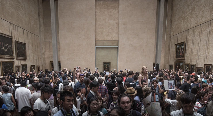massive crowds in front of the very small Mona Lisa at the Louvre