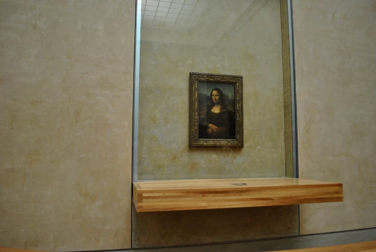 the frequently vandalized Mona Lisa, now behind bulletproof glass