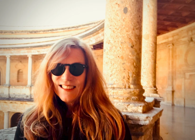 me at the Charles V Palace at the Alhambra with lipstick on my teeth
