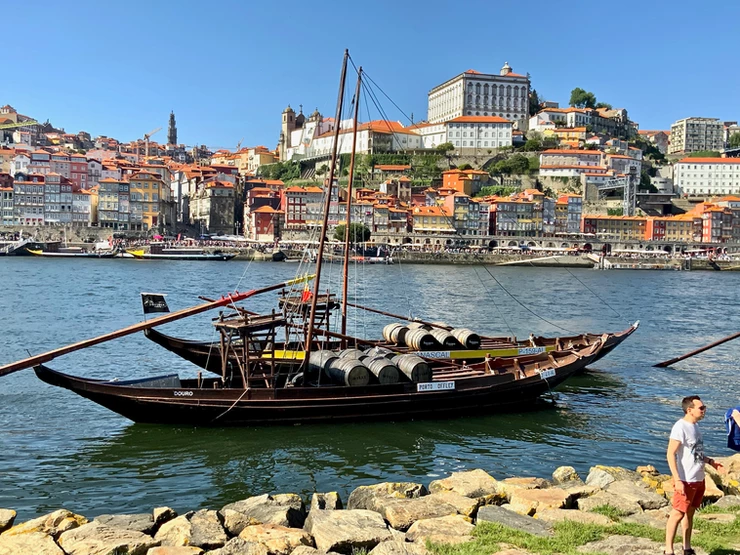 a rabelo boat loaded with caskets of port on the Douro River