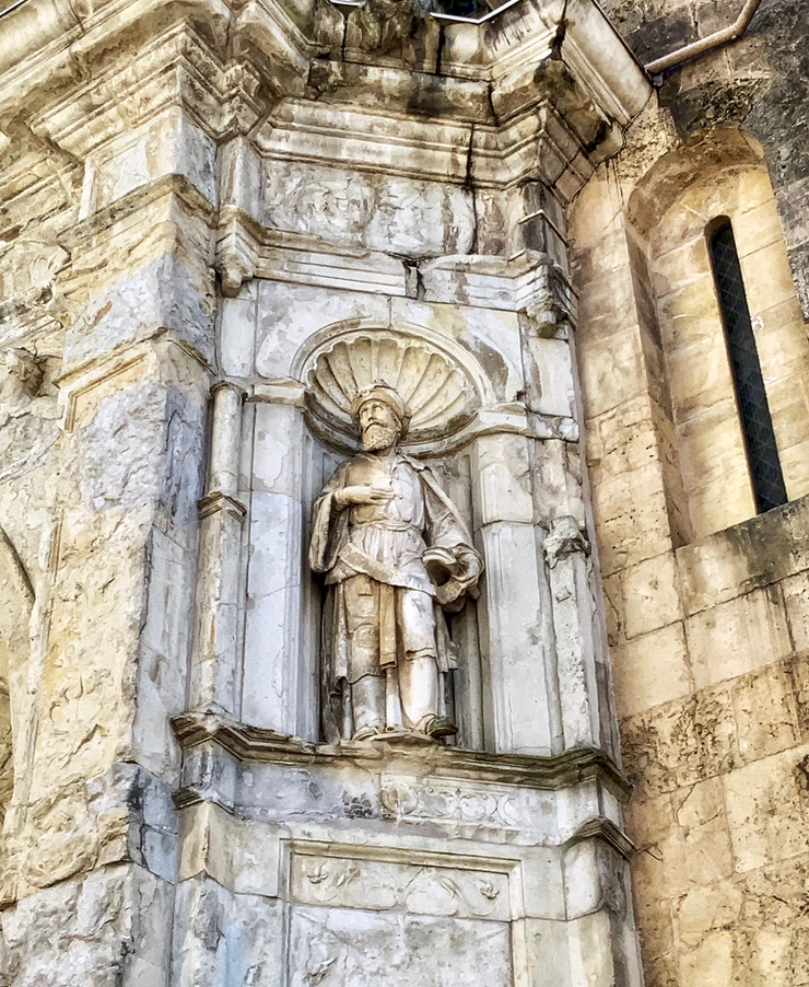 statue in the Beautiful Door of Se Velha Cathedral in Coimbra