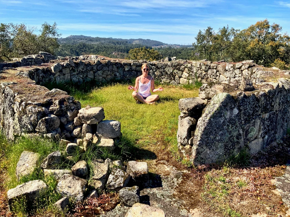my daughter relaxing inside one of the excavated stone huts
