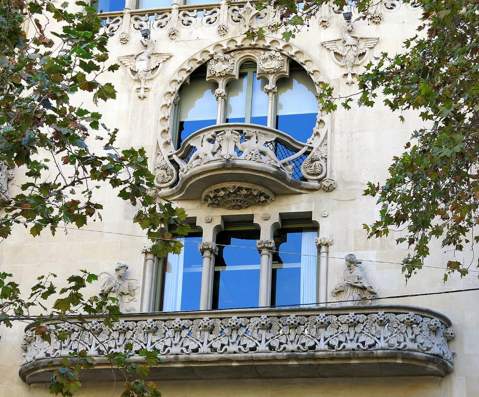 the ornate rounded and elongated balconies on the second and third floor
