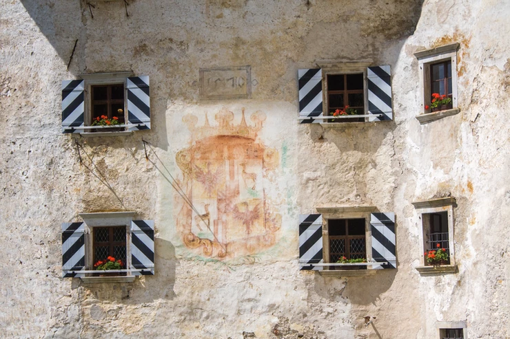 the windows and coat of arms on Predjama Castle