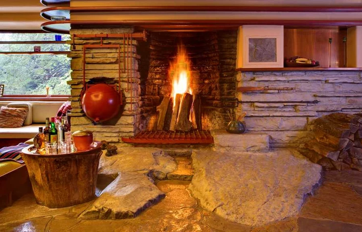 the central fireplace with a built in boulder hearth at Fallingwater