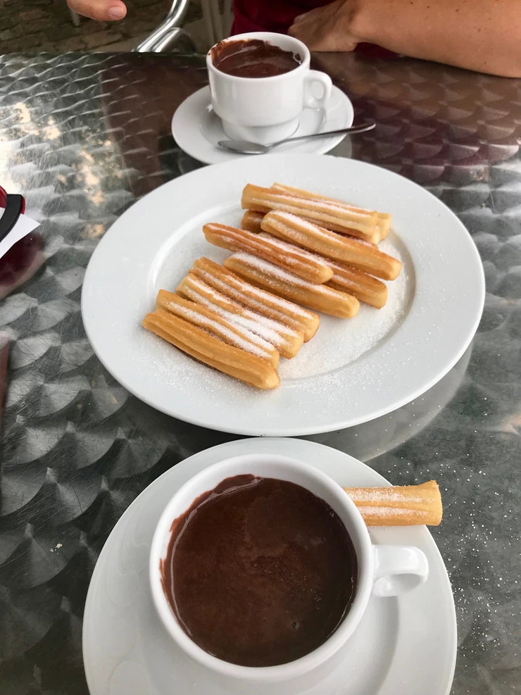 hot chocolate and churros at a cafe in Santillana del Mar