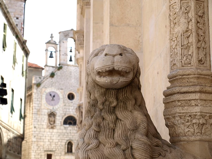 a lion sculpture outside St. James Cathedral in Sibenik