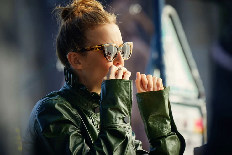 Villanelle spies on Eve, making no attempt to be nondescript in her green ruffle neck leather jacket by JW Anderson 