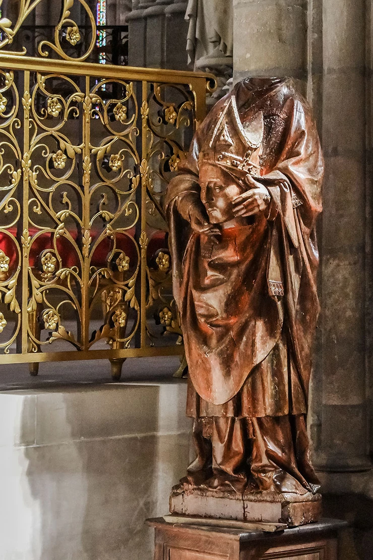 a wooden statue of the famous Cephalophore, Saint Denis, in the choir