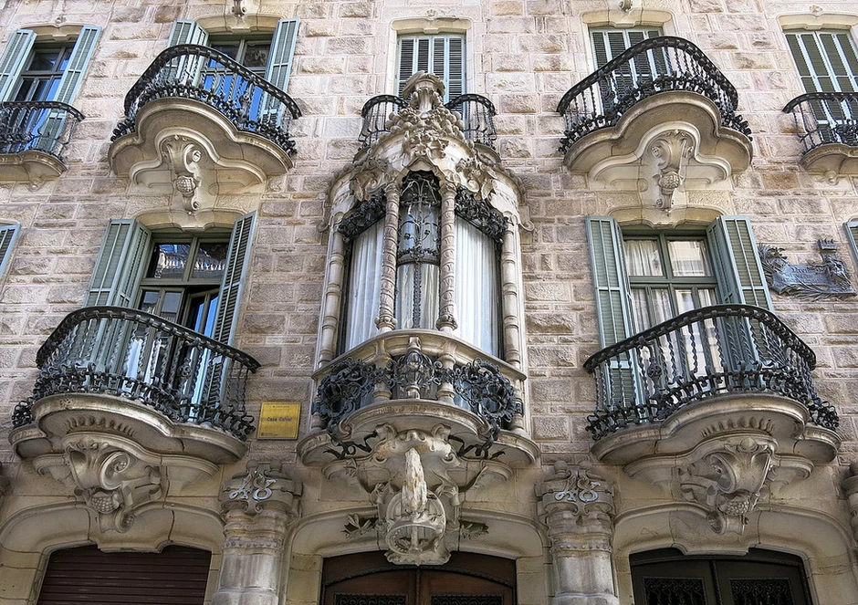 wrought iron balconies on the facade of Casa Calvet