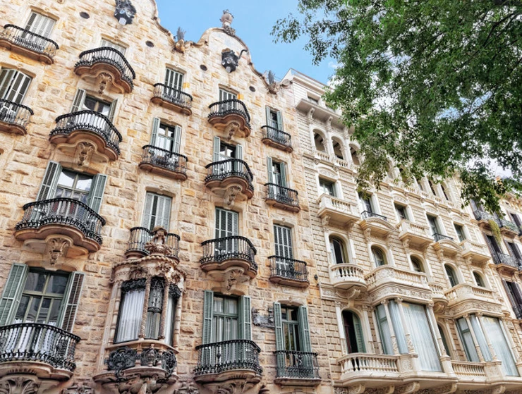 Casa Calvet, on the left with the fancy wrought iron balconies