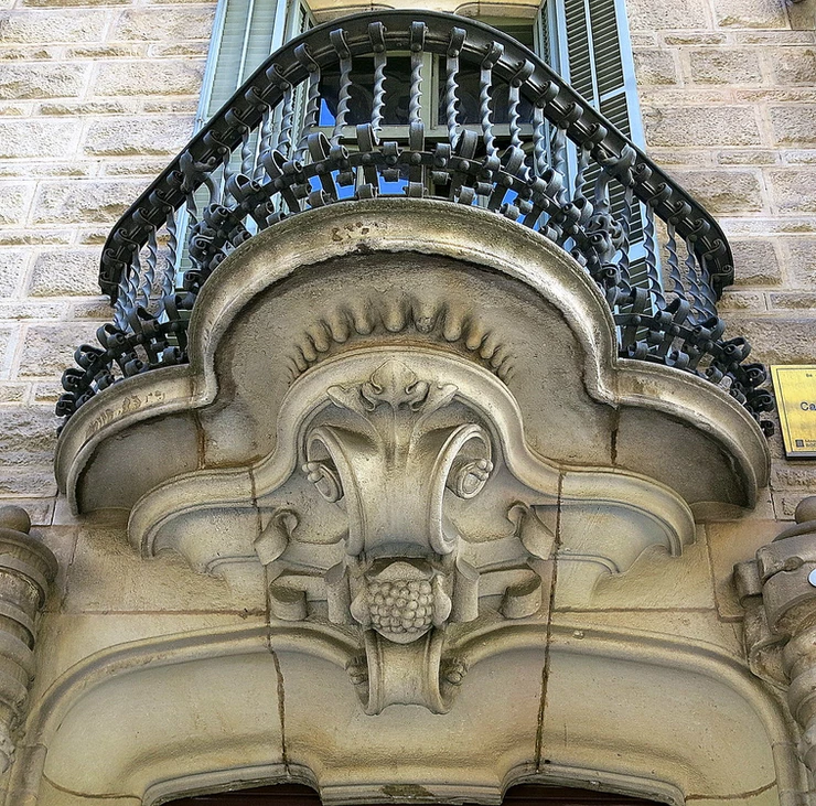 a concrete and wrought iron balcony on Casa Calvet