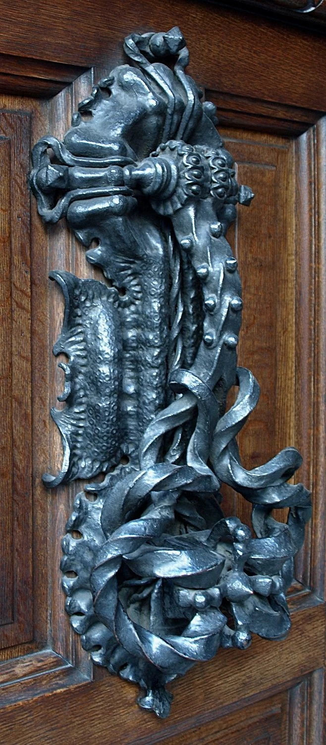 original wrought iron door knocker crushing a bed bug