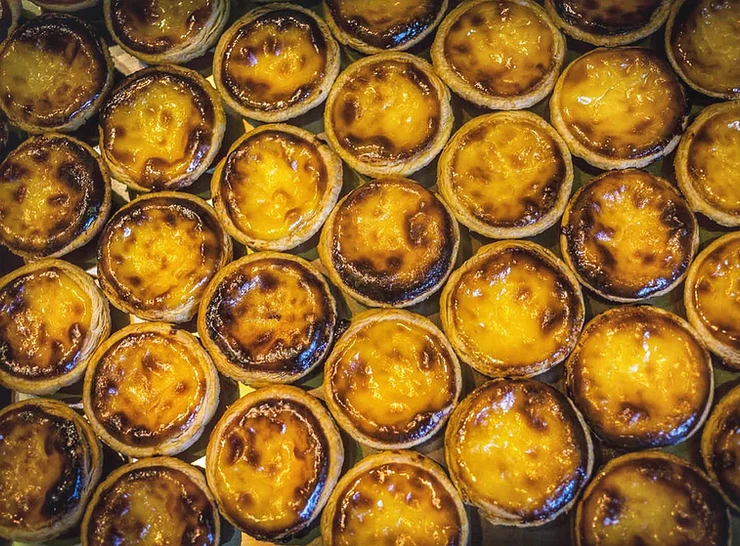 the famous egg custard tarts at Pastéis de Belém, which are a popular thing to do and eat in Belem