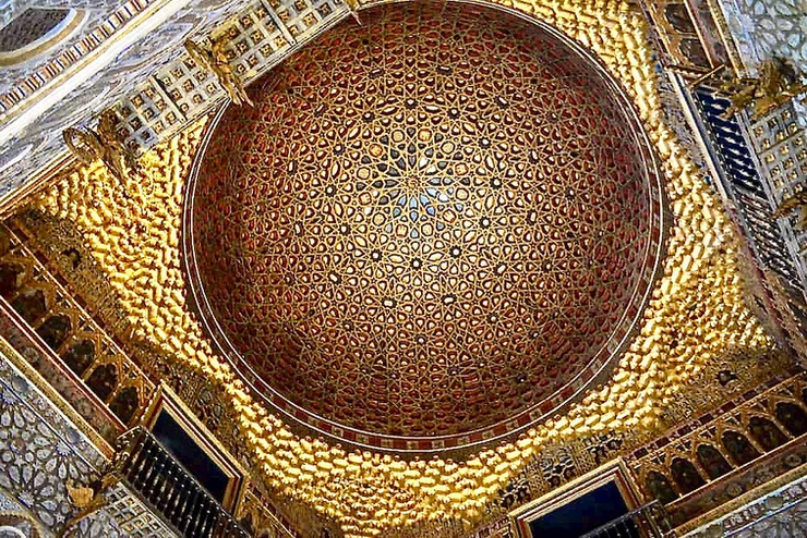 the gold domed ceiling of the Ambassador's Hall in Pedro's Palace in the Alcázar
