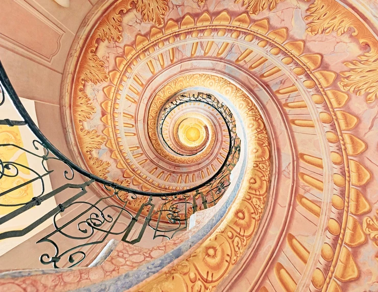 the beautiful pink and gold spiral staircase connecting the library to the church in Melk Abbey