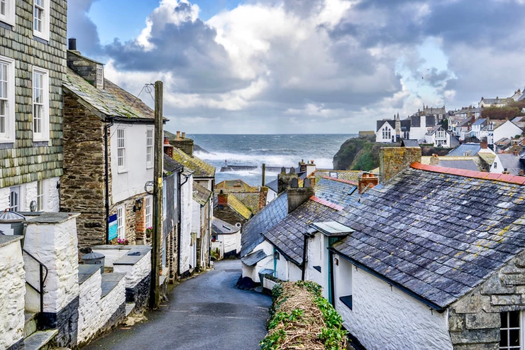 tiny streets of Port Isaac with the Atlantic Ocean crashing in the background 