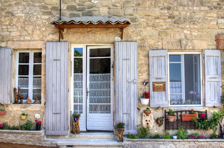 stone house with shutters in pretty Ansouis France