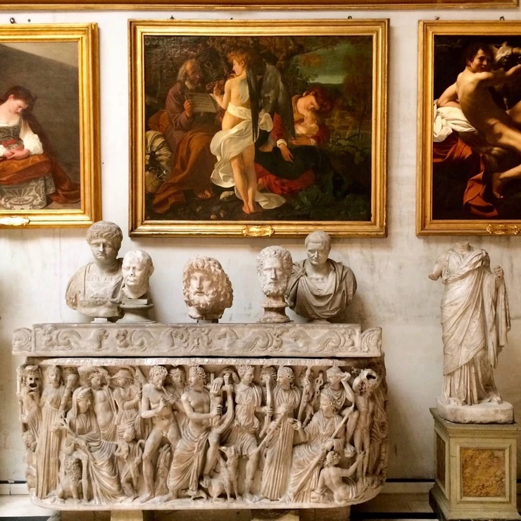sculptures in the Aldobrandini Room of the Doria Pamphilj, with a famous Caravaggio painting above