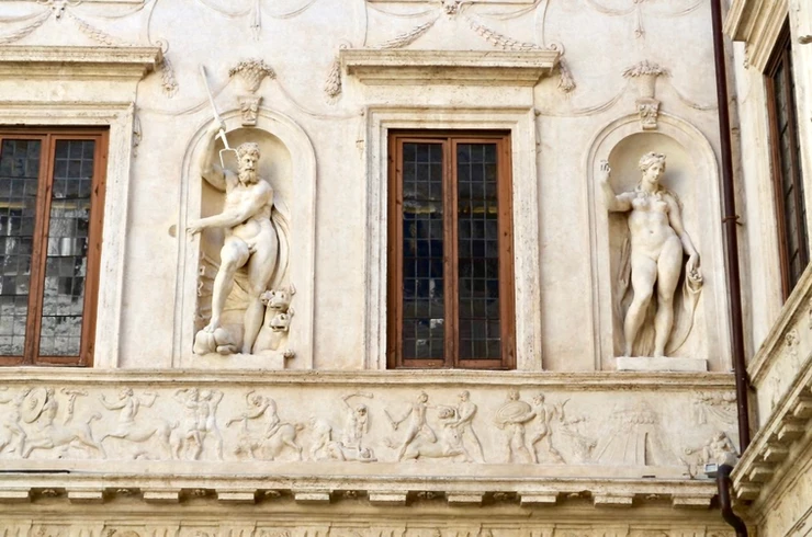 stucco statues of pagan deities Pluto and Persephone decorate walls in the ground floor courtyard 