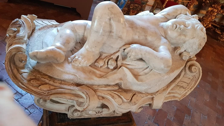 a sleeping putti sculpture in the Galleria Spada
