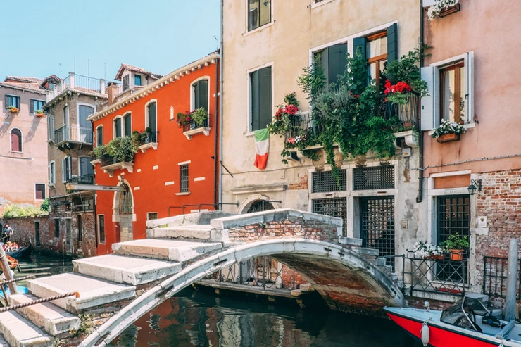 a tiny canal and bridge in Venice Italy