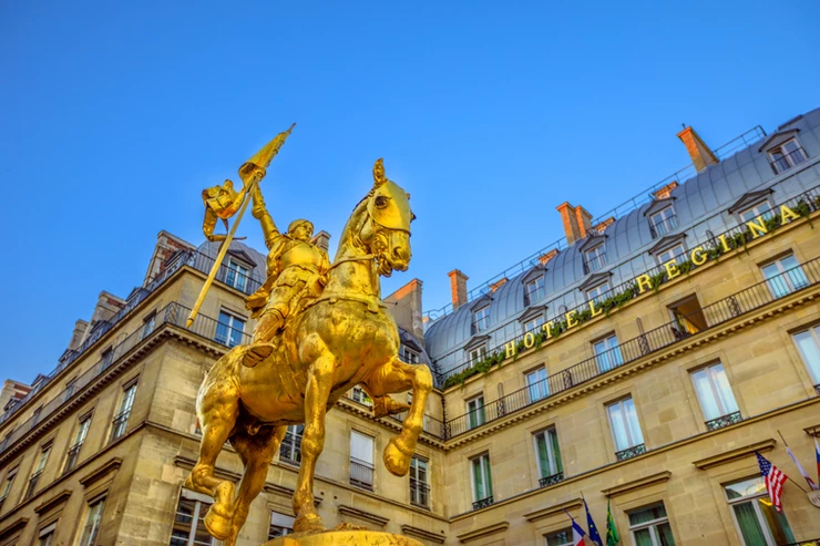 golden equestrian sculpture of Joan of Arc by Emmanuel Fremiet in the square of Louvre Museum Palace