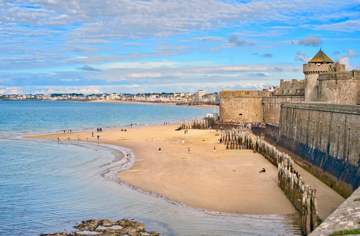 Atlantic beach under the towers of city walls in St Malo