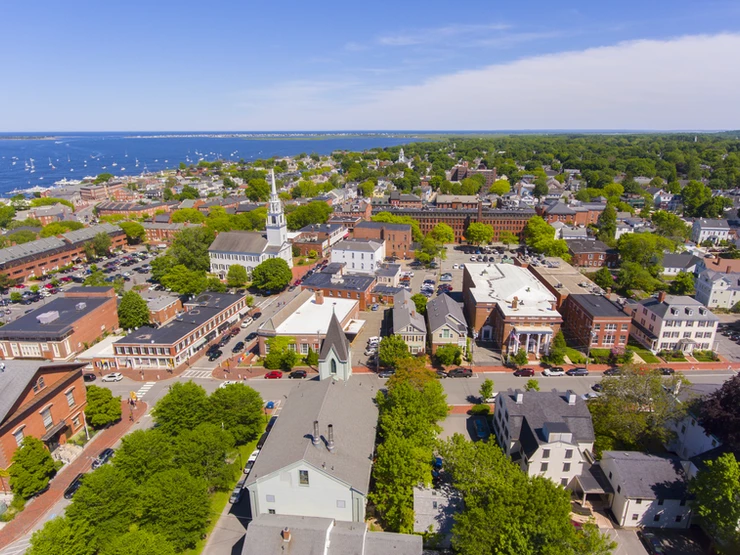 Newburyport historic downtown including State Street and First Religious Society Unitarian Universalist Church with Merrimack River at the background