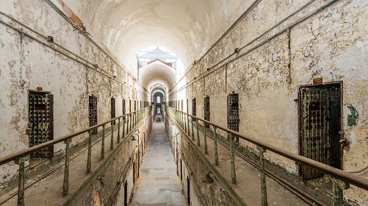 a gloomy long cell block in the Eastern State Penitentiary