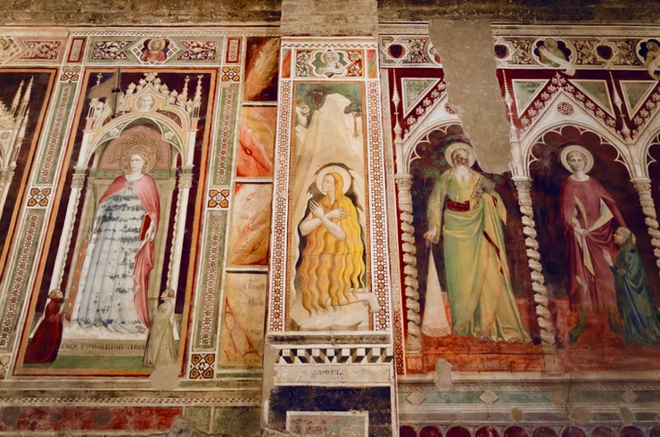 detail of the paintings and frescos from the gothic medieval period on the side walls of the naves