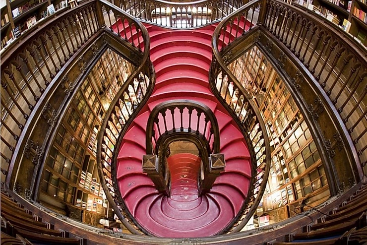dramatic red staircase of Livraria Lello in Porto